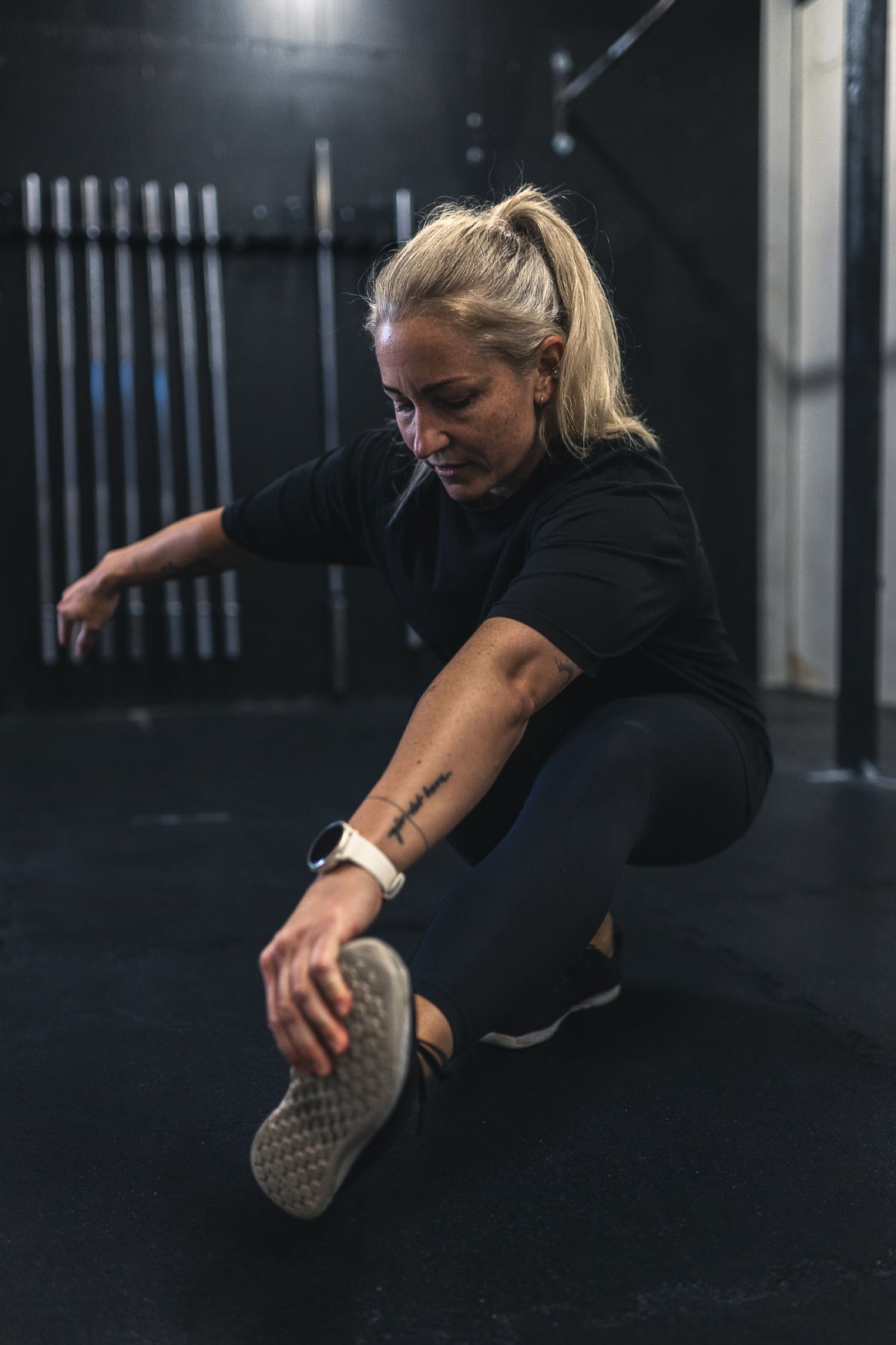 Athlete working through pistol squat mobility on the floor of a Movement Rebels gym